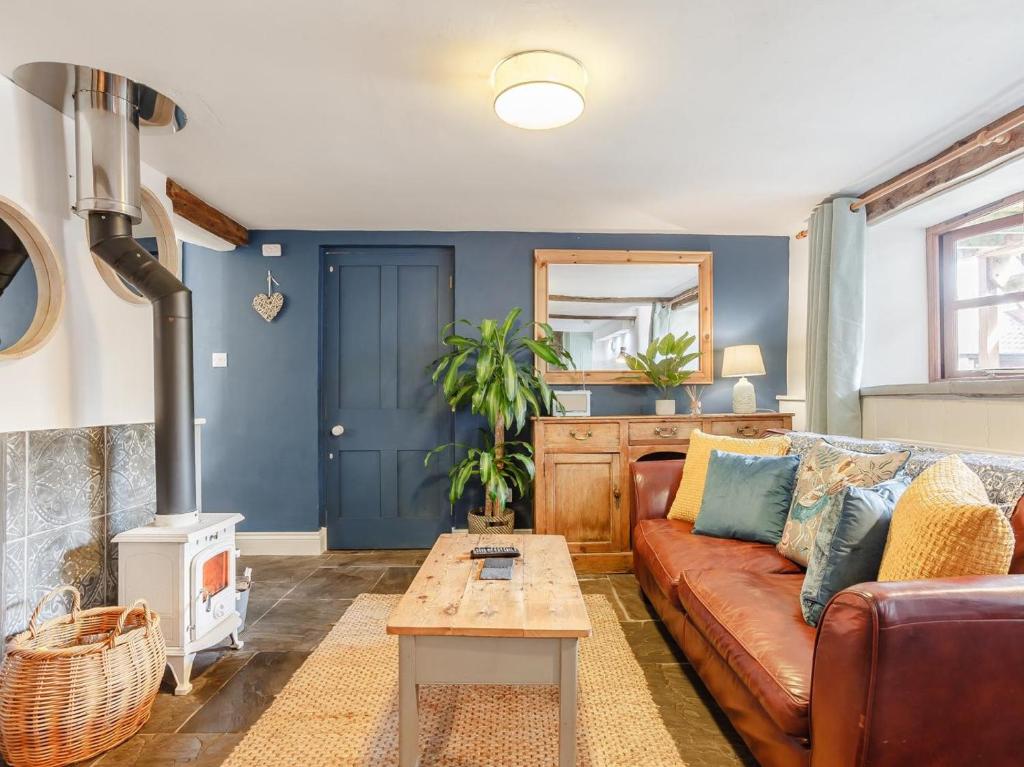 a living room with a couch and a table at 1 Bed in Wedmore oc-51341 in Chapel Allerton