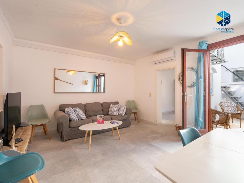 a living room with a couch and a table at Can Tassi in Porto Cristo