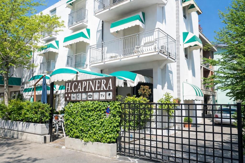 a building with a sign in front of it at Camere Capinera in Cesenatico