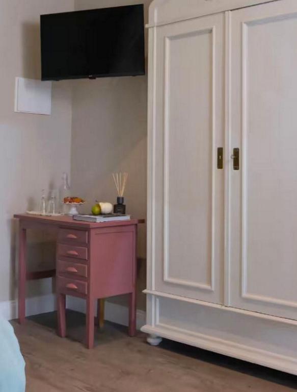 a room with a table and a white cabinet and a table with a tablektop at Casa Martinez Relax Cles in Cles