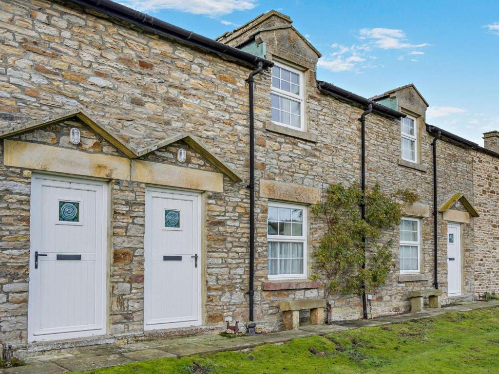 a stone house with white doors and windows at 2 Bed in Consett oc-96375 in Hunstanworth