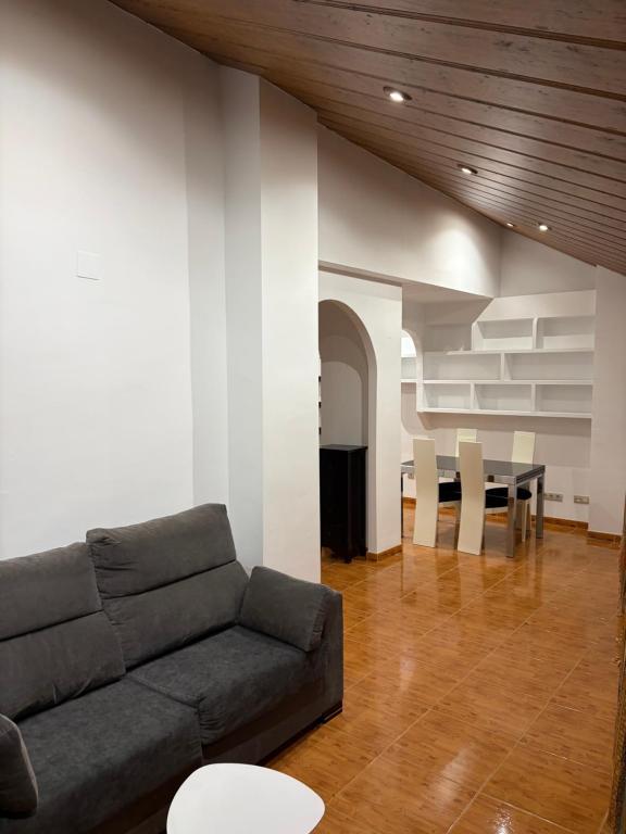 a living room with a couch and a table at Ático centro Benicasim in Benicàssim