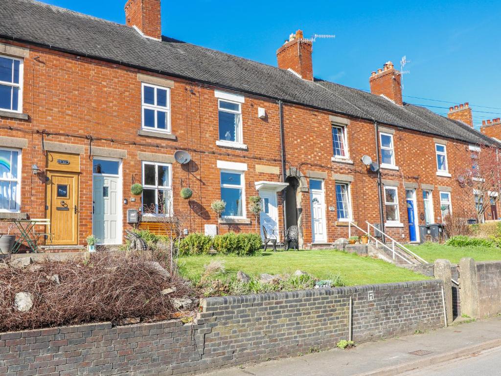 a row of brick houses on a street at Hill View Cottage in Ashbourne