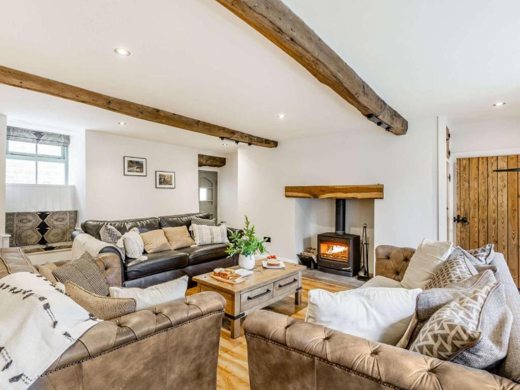 a living room with couches and a fireplace at 3 Bed in Keighley oc-89528 in Haworth