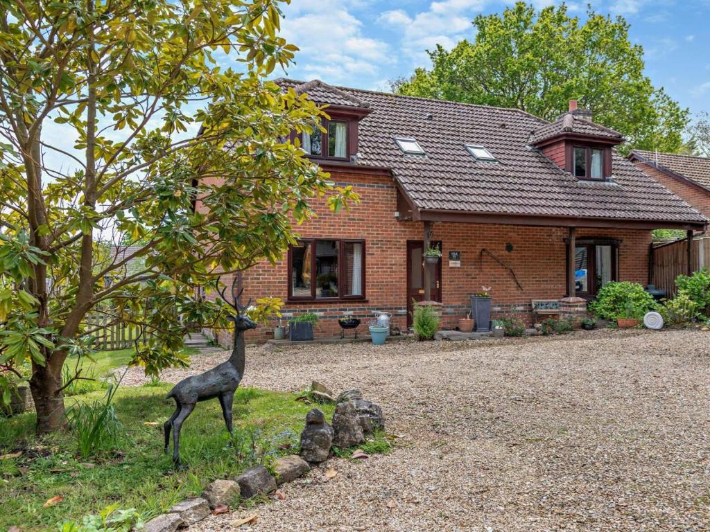 a statue of a giraffe in front of a house at 4 Bed in Wareham oc-77511 in Stoborough