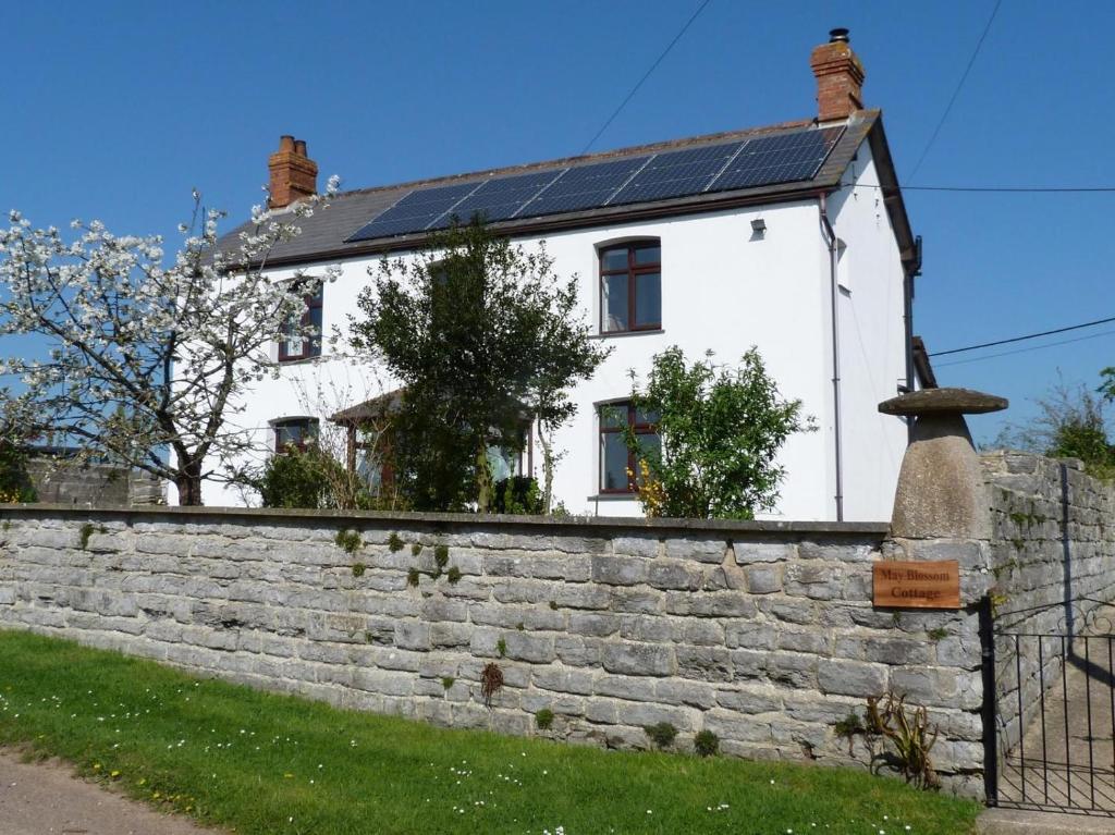 a white house with solar panels on a wall at 1 Bed in Taunton oc-49569 in North Curry