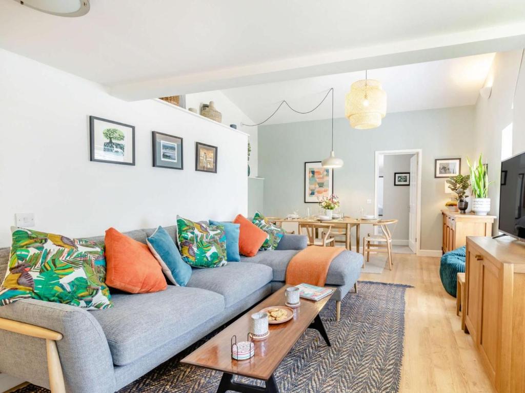 a living room with a blue couch and a table at 2 Bed in Taunton oc-88884 in Isle Brewers