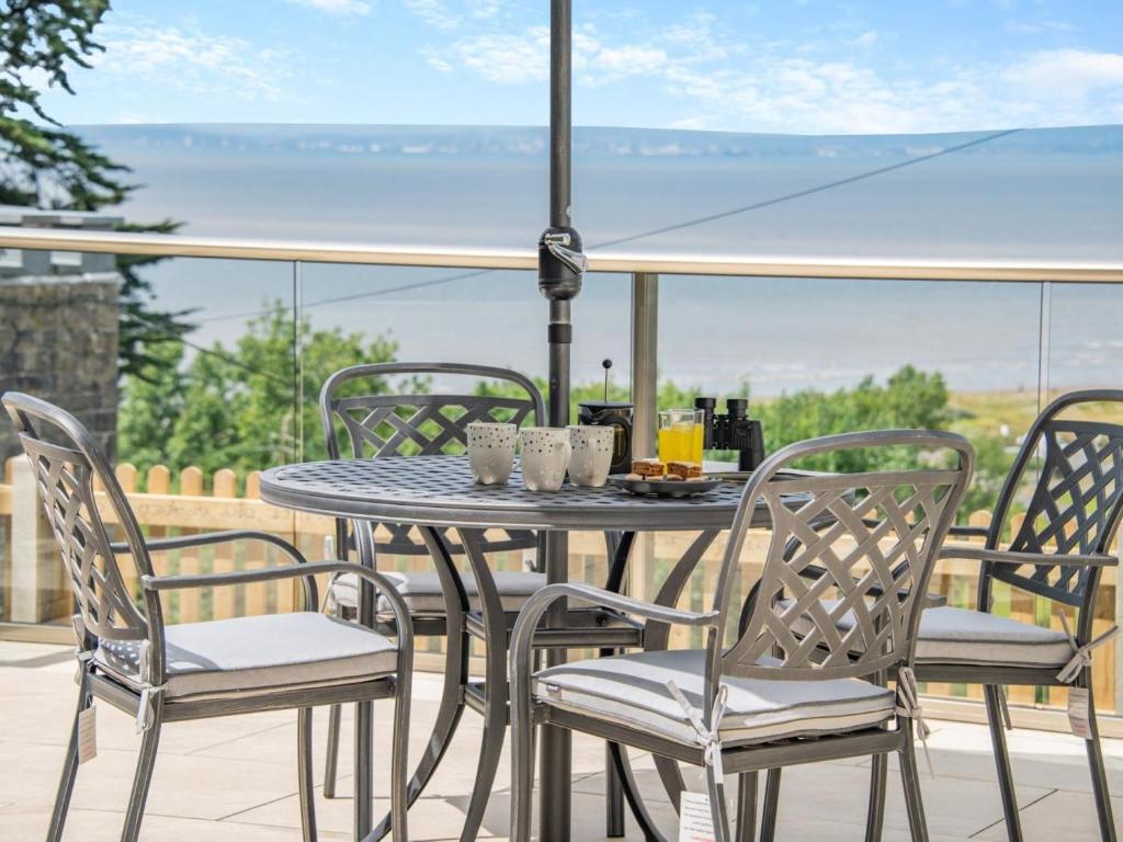 a table and chairs on a patio with a view of the ocean at 2 Bed in Weston-super-mare oc-94385 in Worle