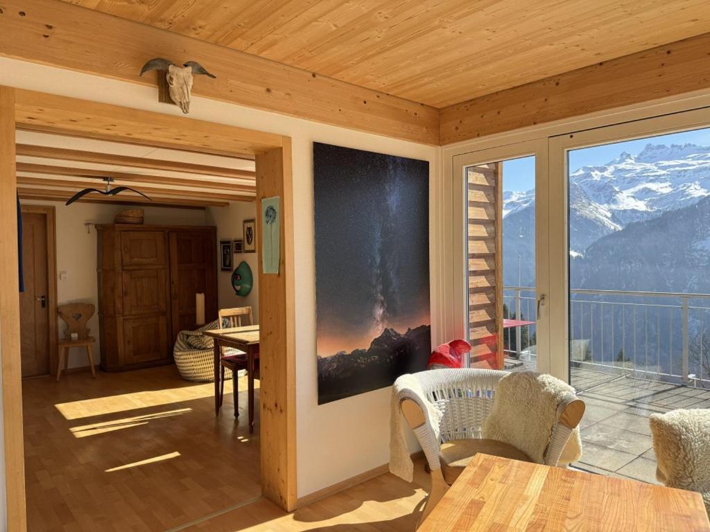 a room with a balcony with a view of a mountain at Revier Schwettiberg Nr. 1 in Braunwald