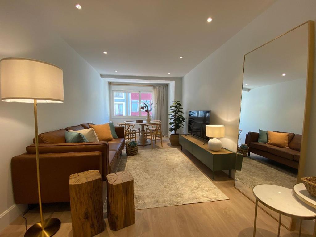 a living room with a couch and a table at 'Socaire' Ribadesella in Ribadesella