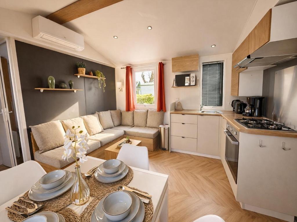 a kitchen and living room with a couch and a table at Eden Cottages - Premium Cottage avec Piscine in Antibes
