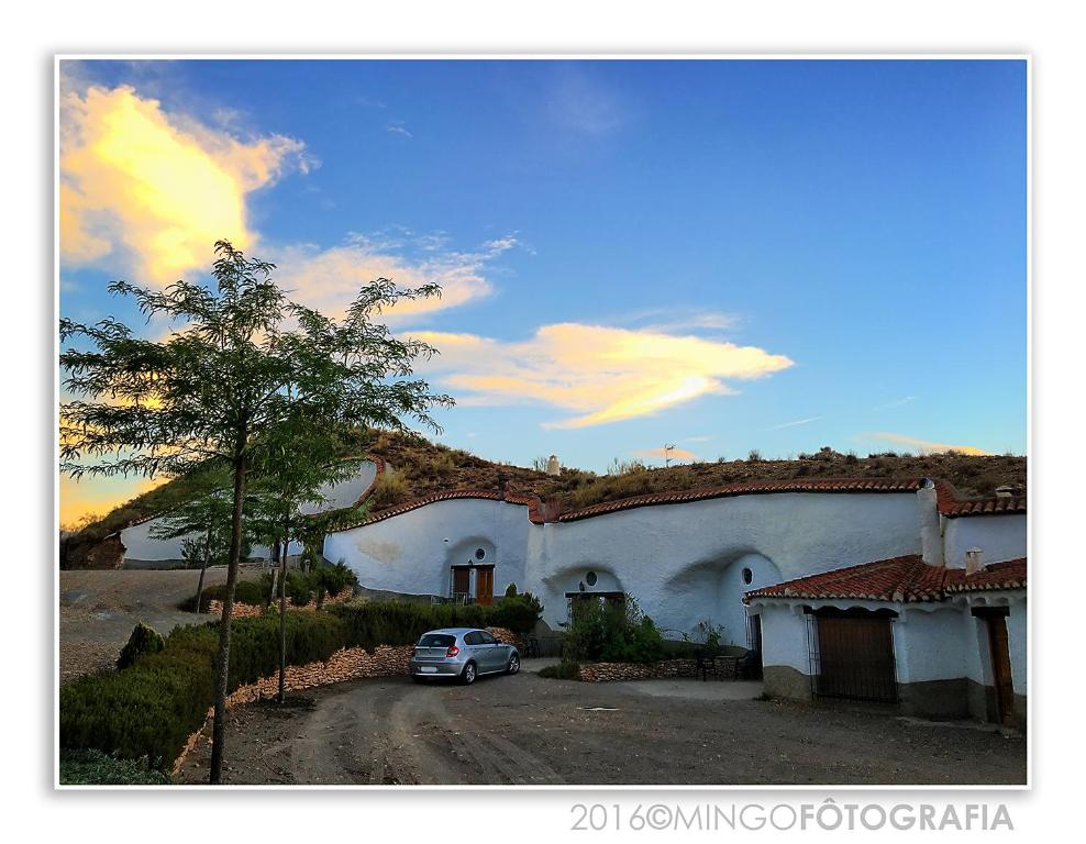 a car parked in front of a building at Cuevas Del Zenete in Alcudia de Guadix