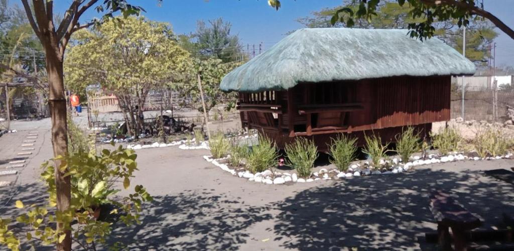 a small building with a grass roof at Cristy & Ashley's Sunny Place in Rimus