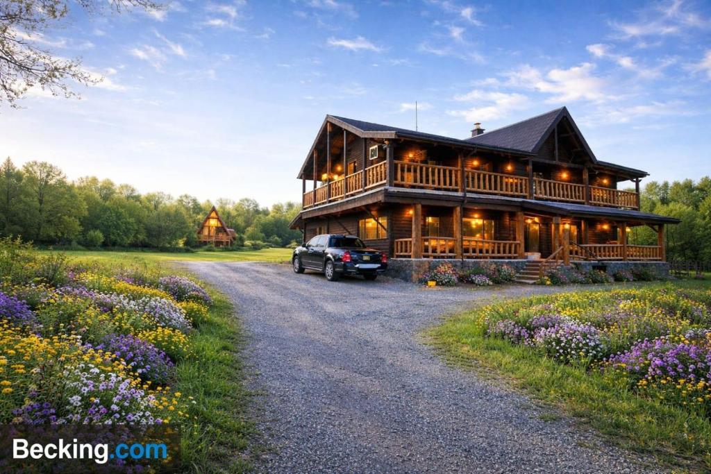 a car parked in front of a large wooden house at Casa Hiru in Nucşoara