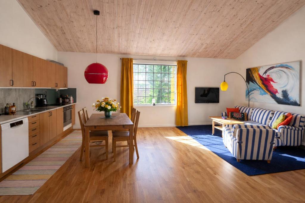 a kitchen and living room with a table and a couch at The Studio in Skellefteå