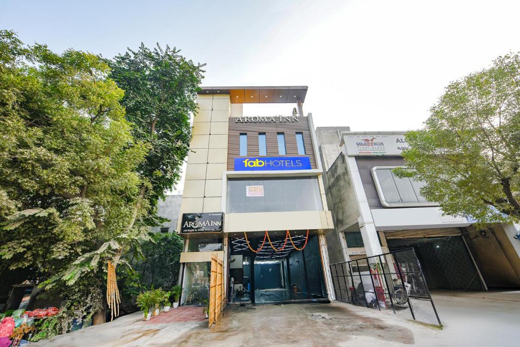 a building with a basketball hoop in front of it at FabHotel Kavya Inn - Nr The Mall of Faridabad in Faridabad