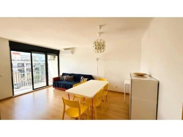 a living room with a table and a couch at Apartamento Summer Place in Monte Gordo