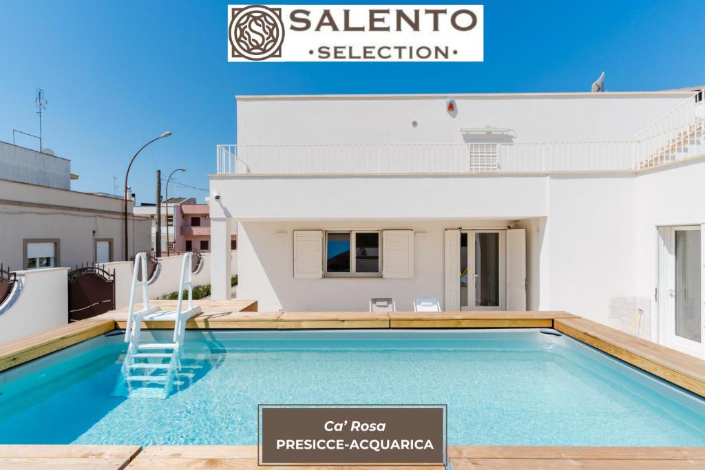 a villa with a swimming pool and a sign that says cal most prestige aquarium at Ca' Rosa - Salento Selection in Acquarica del Capo