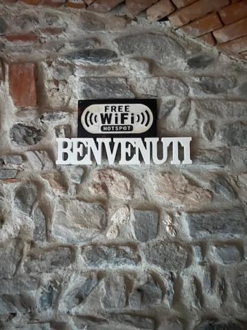 a sign on the side of a brick wall at Antico Glicine in Ispra