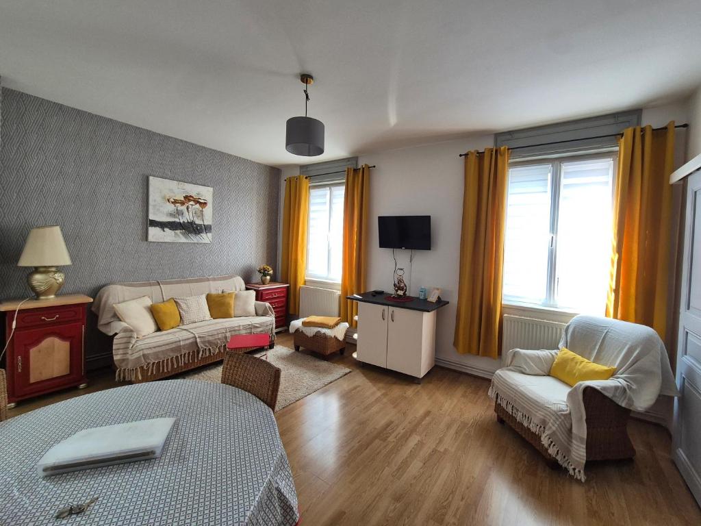 a living room with a couch and a table at appartement meublé romain in Niederbronn-les-Bains