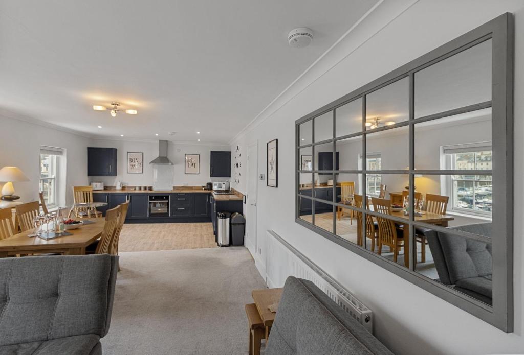 a living room with a dining room and a kitchen at Quayside Marina in Torquay