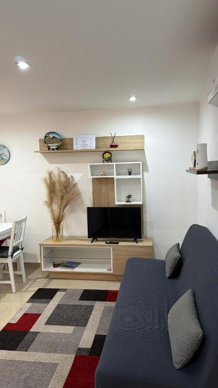 a living room with a tv and a couch at BELLO BORGO in Taranto