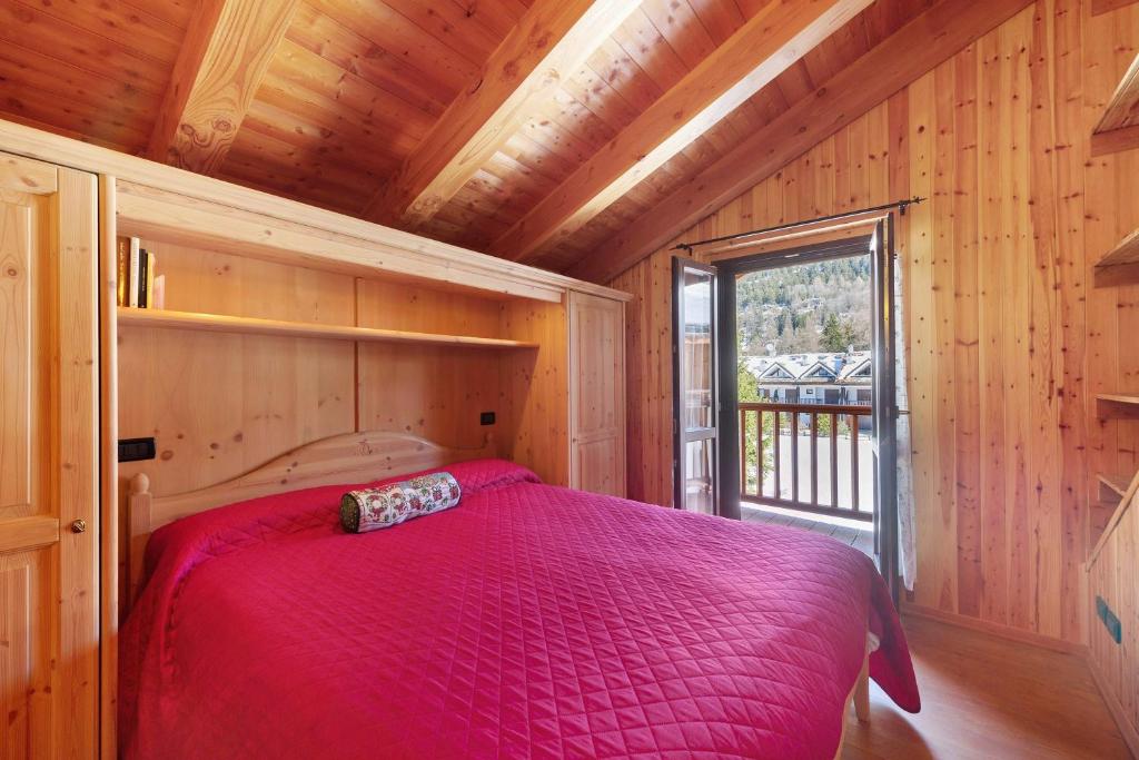 a bedroom with a bed in a room with a window at La Maison de Marguerite in Saint Vincent