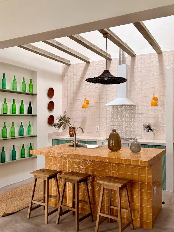 a kitchen with a brick counter and stools at Fronteira in Fronteira