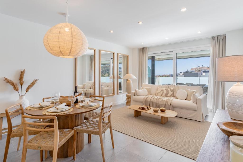 a living room with a table and a couch at Casa Cala Serena in Mijas