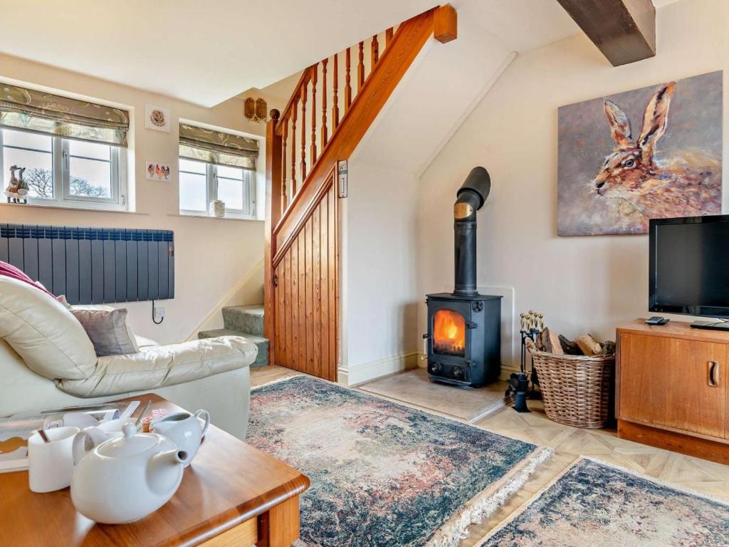 a living room with a wood stove in a house at 1 Bed in Sherborne oc-93804 in Yetminster