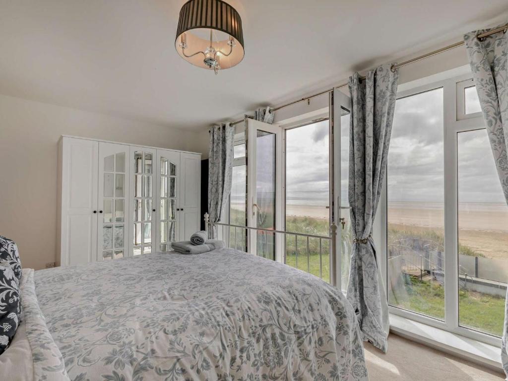 a bedroom with a bed and a large window at 3 Bed in Burnham-on-sea oc-92964 in Brean