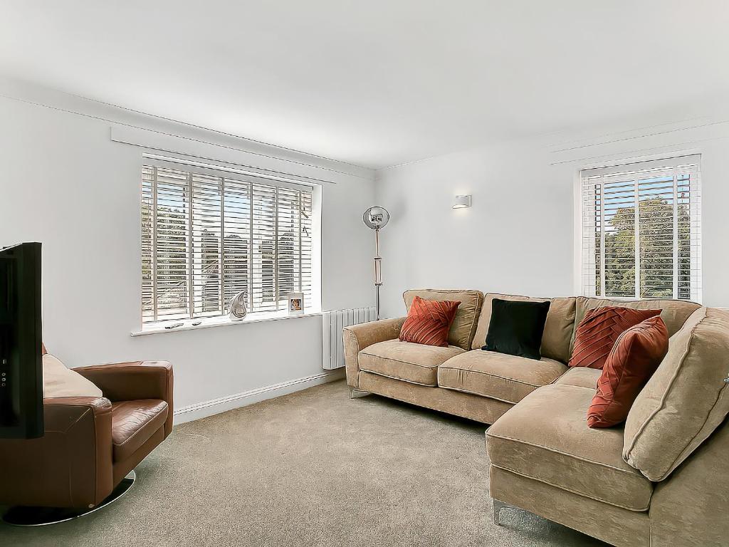 a living room with a couch and a chair at Central Sherborne in Sherborne