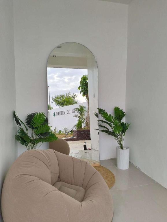a circular chair in a room with a mirror at Casa de Matilda in Silang