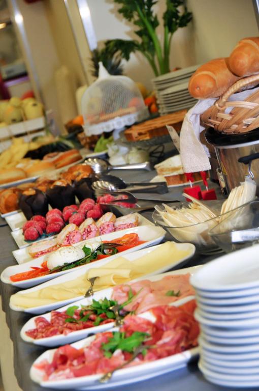 a buffet with many plates of food on a table at Hotel Venezia in Caorle