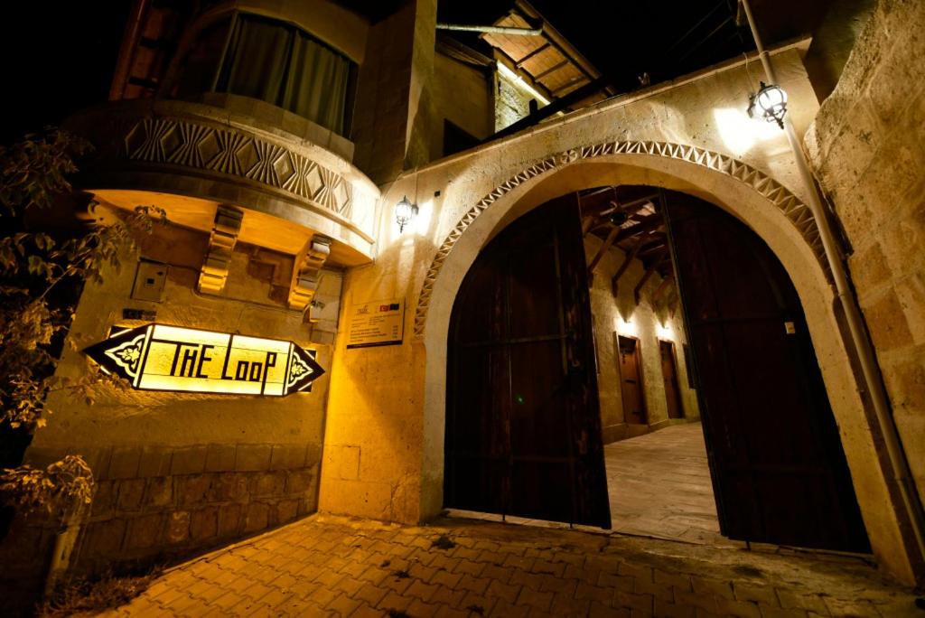 a sign on the side of a building at night at The Loop Cappadocia in Avanos