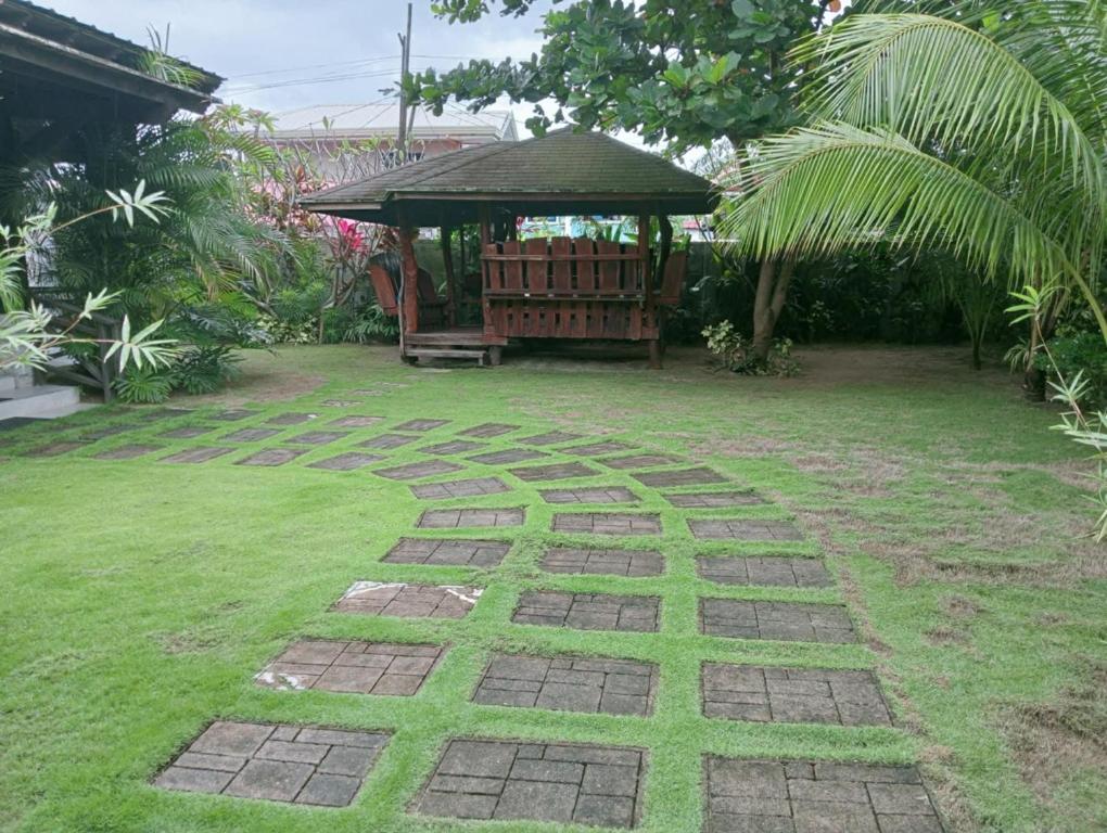 a garden with a gazebo and a lawn at Uya Mina Homestay in General Luna