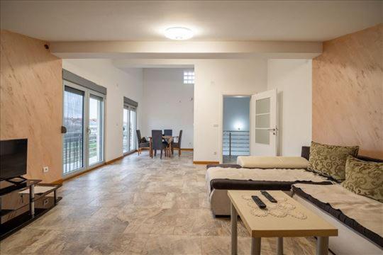 a large living room with a couch and a table at Super Vila in Jajinci