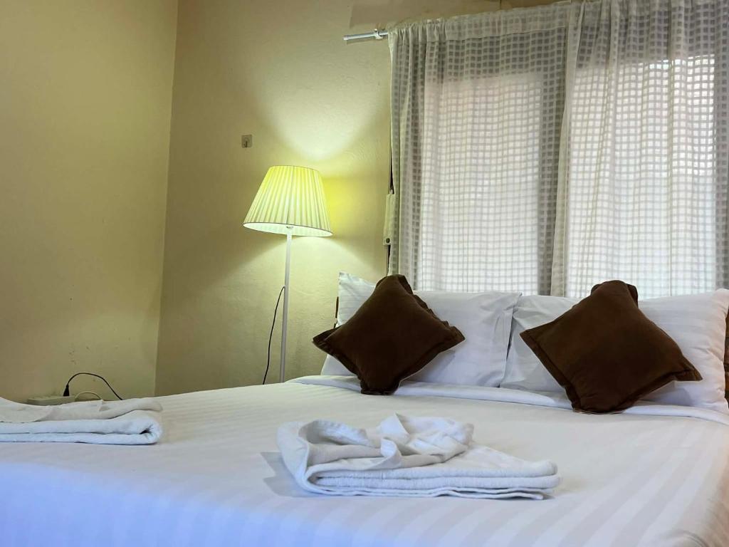 a bedroom with a bed with towels on it at Yao noi cozy home in Ko Yao Noi