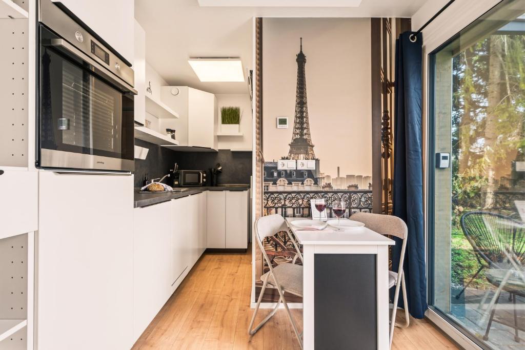 a kitchen with a table and a view of the eiffel tower at Holiday&Stay, Tiny living in Fronreute