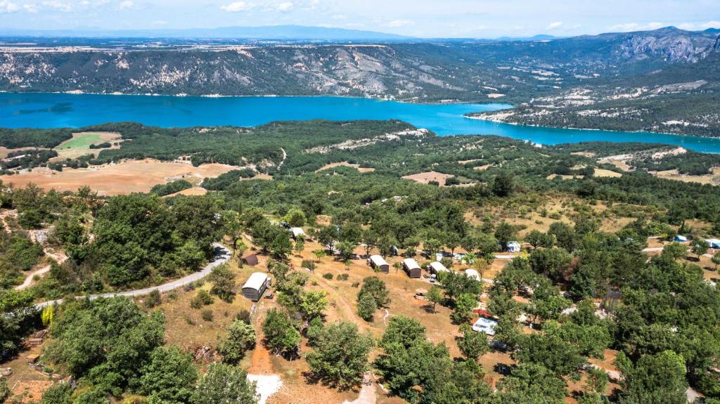 an aerial view of a farm with a lake at Campasun Camping de l'Aigle in Aiguines