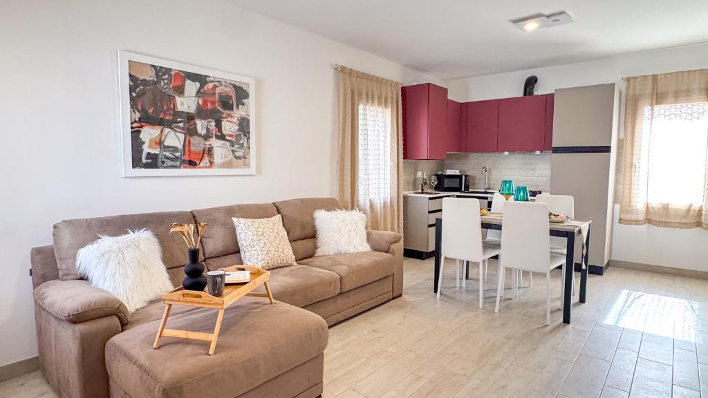 a living room with a couch and a table at Imperial Golden Suite by Ca-Sa Check in Chioggia