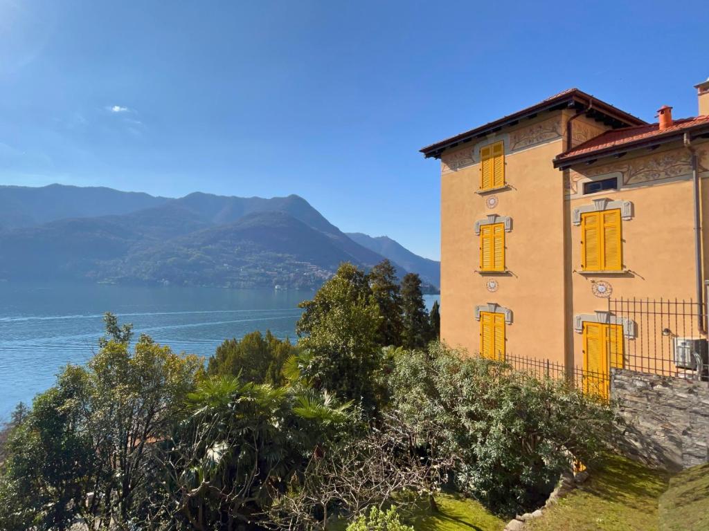 a building on the side of a body of water at Villa Eugenia - Suite Iris in Carate Urio