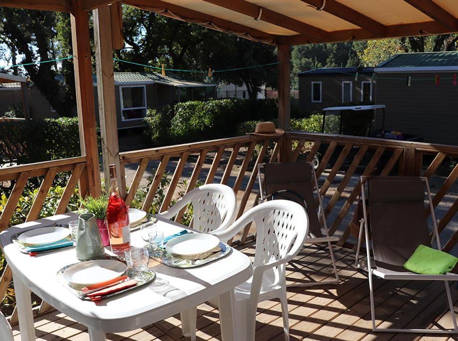 a white table and chairs on a deck at Camping Mas De Pierredon in Sanary-sur-Mer