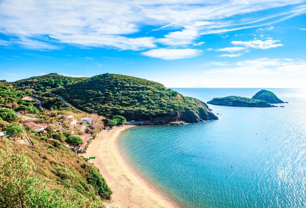 an island in the ocean with a sandy beach at Glamping Elba in SantʼAnna