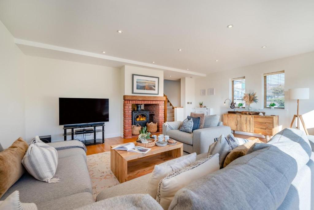 a living room with two couches and a fireplace at 4 Bed in Newquay oc-b27906 in Newquay