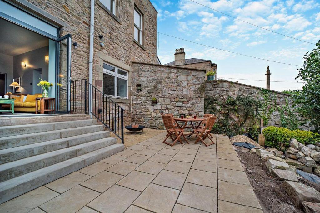 a patio with a table and chairs in front of a building at 2 Bed in Coldstream oc-t30042 in Coldstream