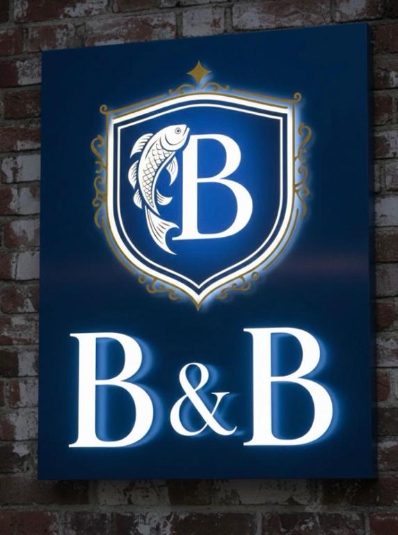 a sign on a brick wall with the bbc logo at BLUE Airuno in Airuno