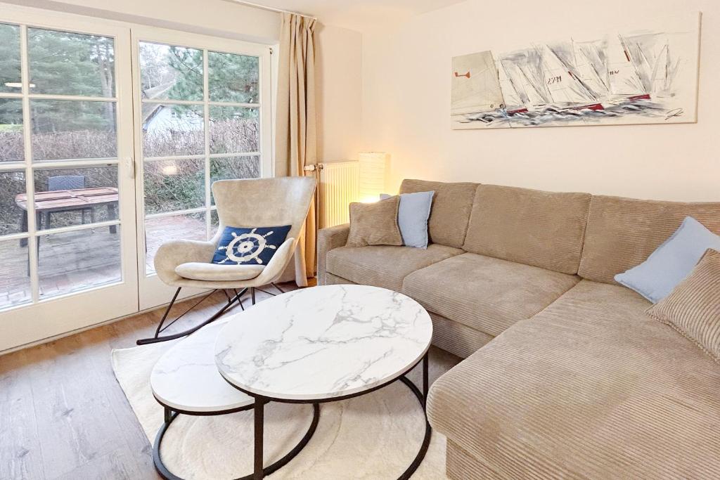 a living room with a couch and a table at Achtern Diek Haus 12d Wohnung 1 PALSTEK in Müggenburg