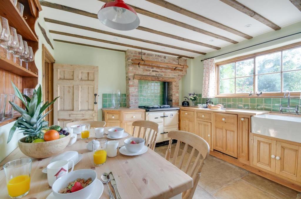 a kitchen with a wooden table with food on it at 3 Bed in Crayke oc-y056 in Crayke