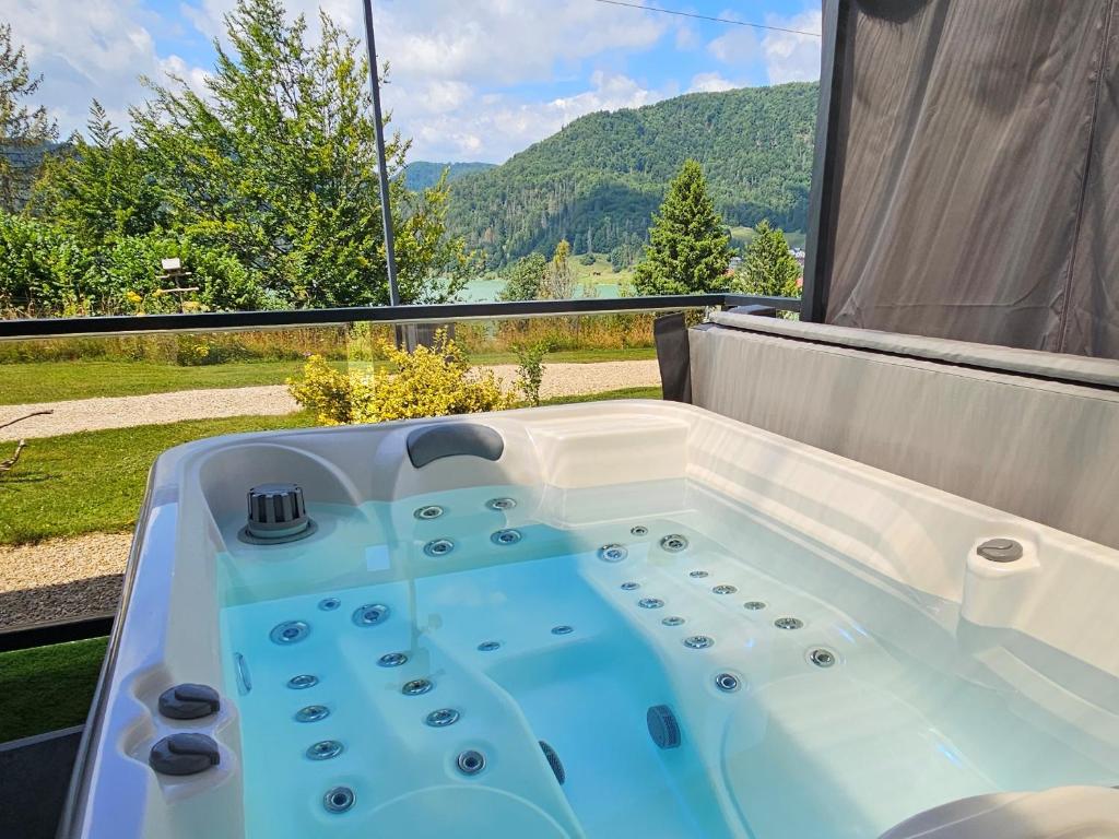 a bath tub with a view of a mountain at Tiny House 2 Dedinky Privat Wellness in Dedinky